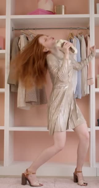 Attractive redhead woman dancing as rock star holding shoe in hands, in party dress — Vídeo de Stock