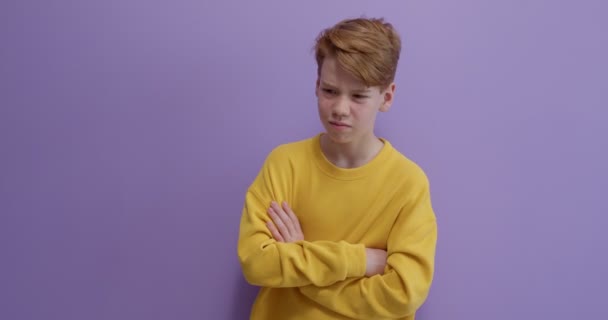 Young boy thinking daydreaming deeply about something, isolated on purple background. — Stock Video