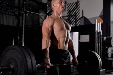 Cool strong caucasian male with confident face exercising holding equipment up