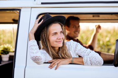 happy adult woman portrait outside the window of van vehicle in travel lifestyle activity