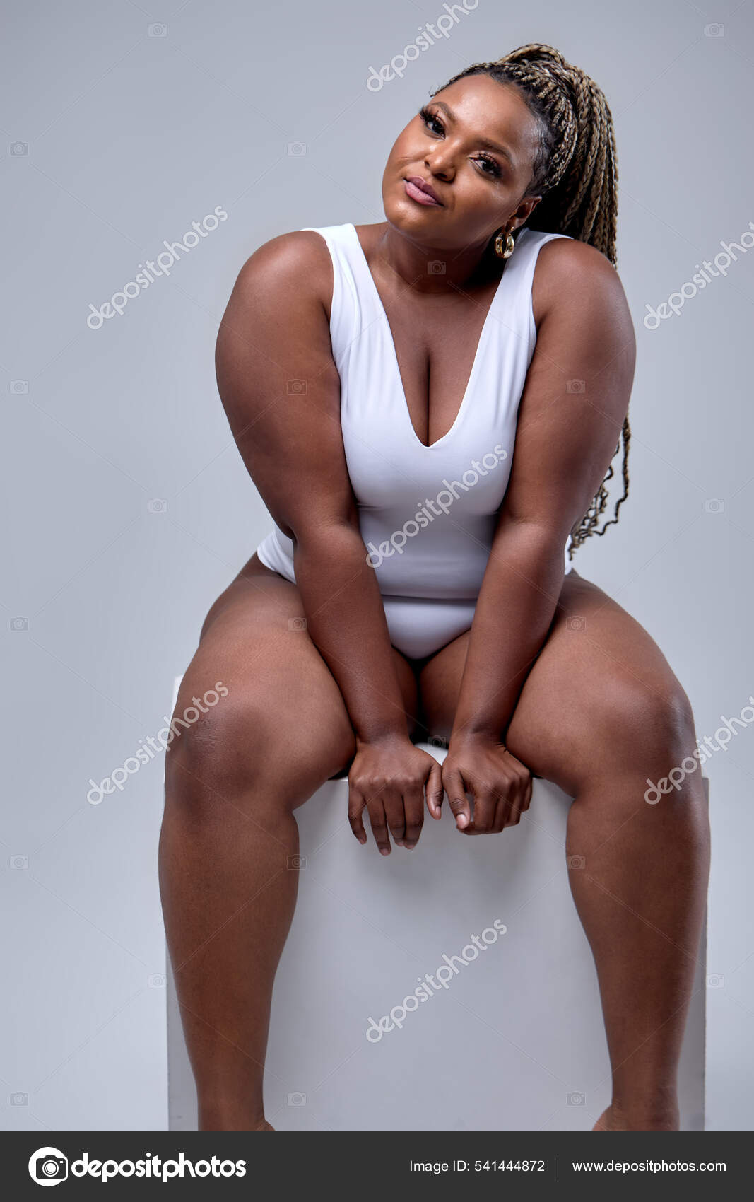 Portrait Of Shy Young Black American Woman In Bodysuit Over White  Background Stock Photo by ©romanchazov27 541444872