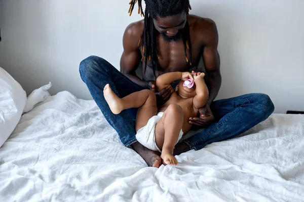 Jonge zwarte vader die pasgeboren baby knuffelt. schattige pasgeboren baby in handen van papa. — Stockfoto