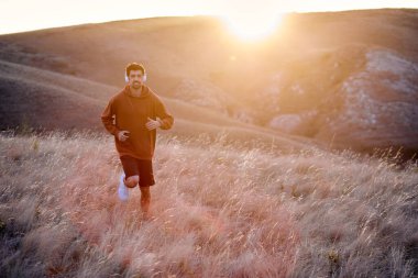 Sporcu koşuyor. Koşucu maraton koşusu için antrenman yapıyor. Genç güçlü erkek.