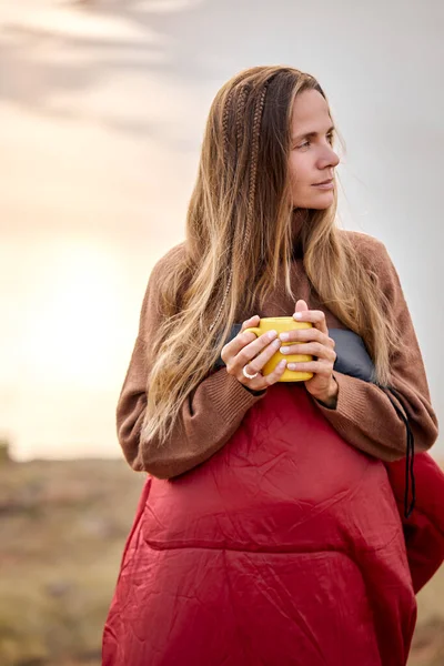 Beautiful female holding cup of tea in hands standing in contemplation of nature — Stock Photo, Image