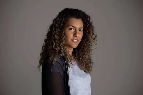 Black curly hair girl posing for photo. Side view of lovely woman and big wavy hair.