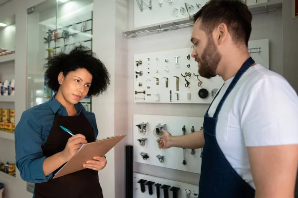 african american business woman talking to colleague about sales and training at utility store