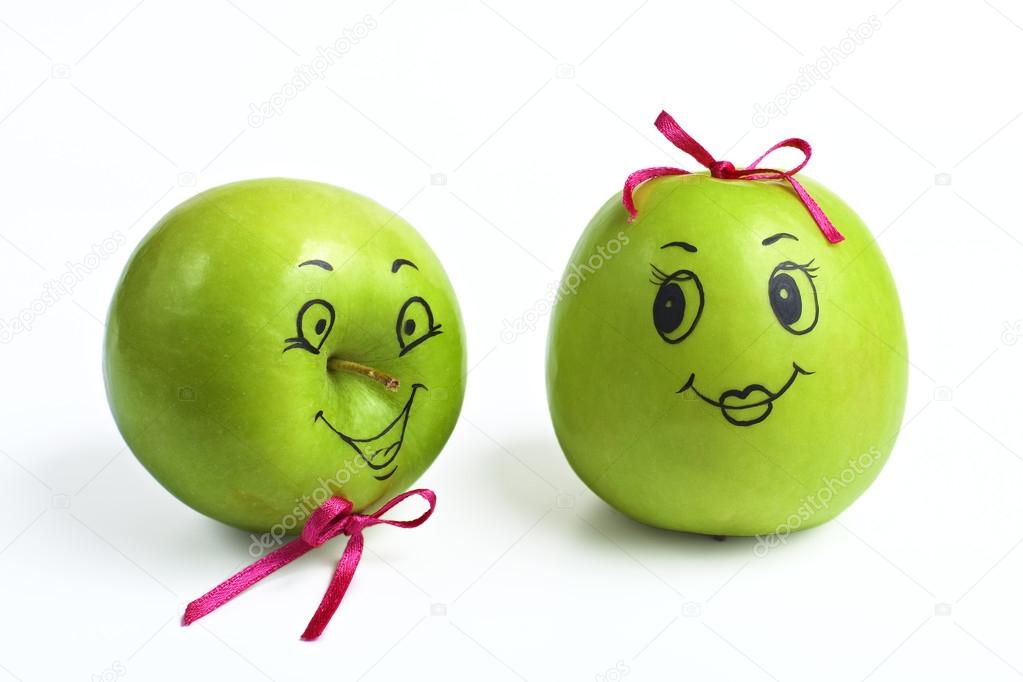 apples with comically painted faces on a white background