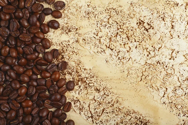 Coffee beans on abstract background with streaks and stains — Stock Photo, Image