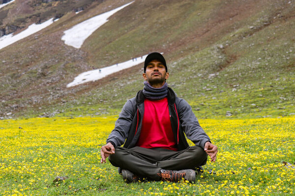 Meditating in nature in the middle of mountains