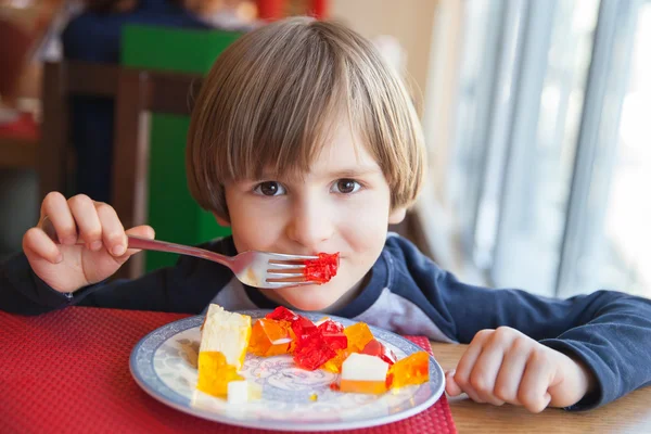 The boy with plate of colored gelatins — Stock Photo, Image