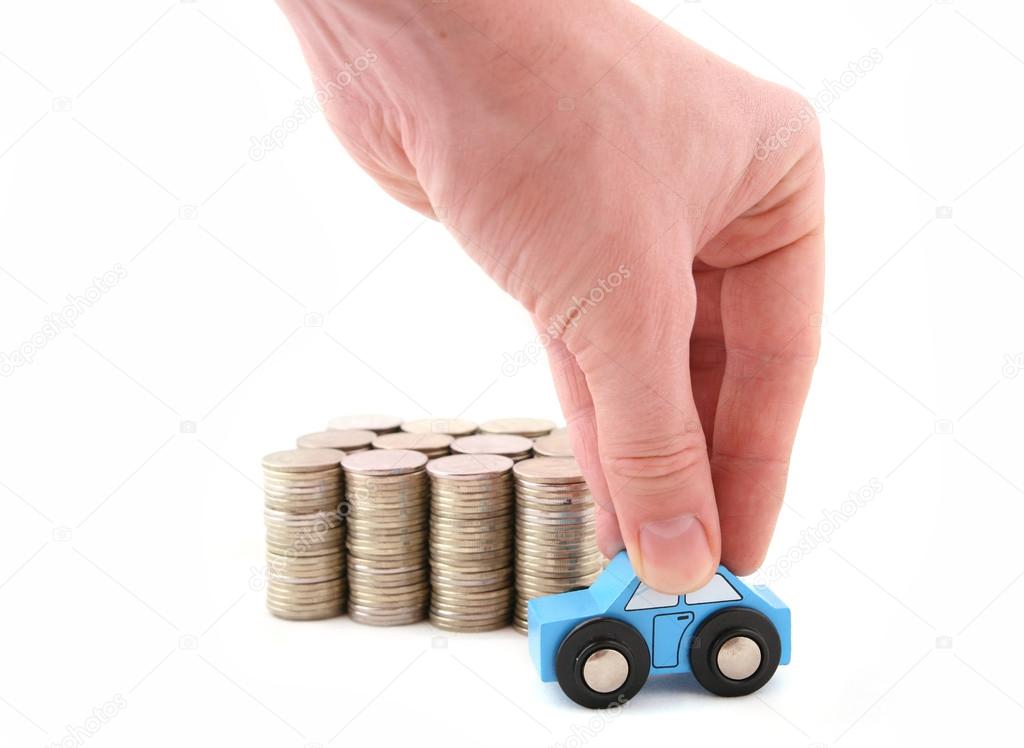 Columns of coins and hand with toy car