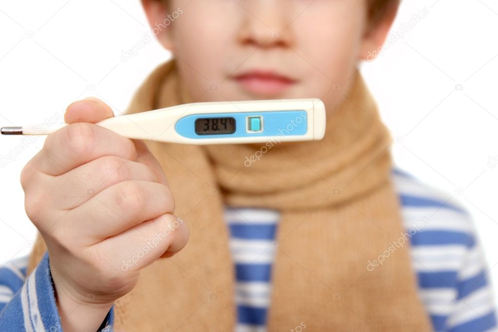The thermometer in a hand of the boy