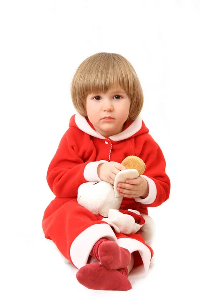 Kleine santa met een stuk speelgoed — Stockfoto