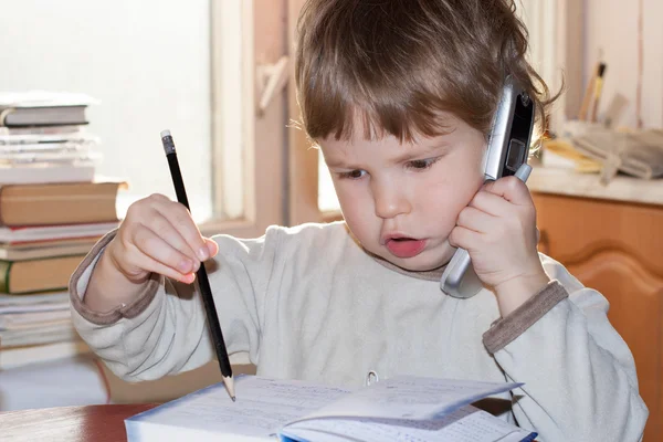 Boy with pencil and mobile phone — Stock Photo, Image