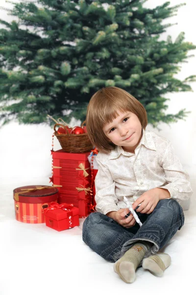 Boy holds christmas presen — Stock Photo, Image