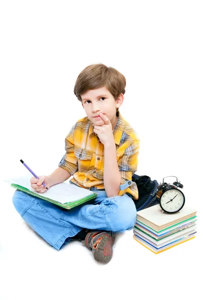 Schoolboy with notebook on his knees — Stock Photo, Image