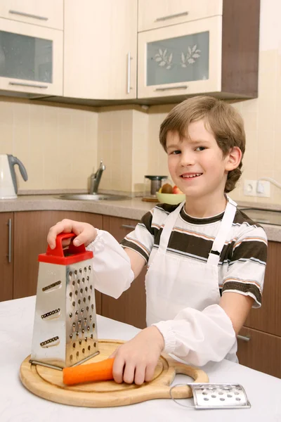 Boy with graters and carrot — Stock Photo, Image