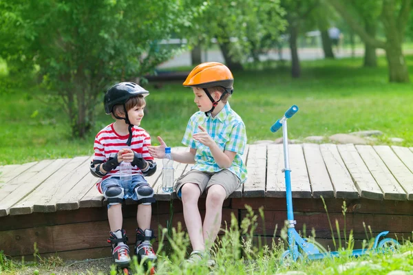 Children with rollers and scooter — Stock Photo, Image