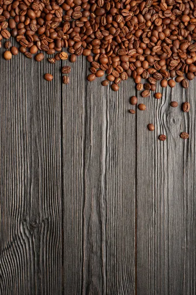 Coffee beans on old wooden dark planks background — Stock Photo, Image