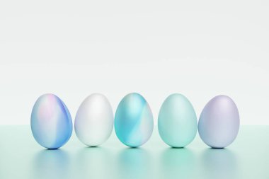 3 boyutlu pastel mavi paskalya yumurtası, yeşil arkaplanda.
