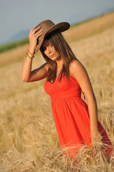 Portrait of young woman in yellow wheat field