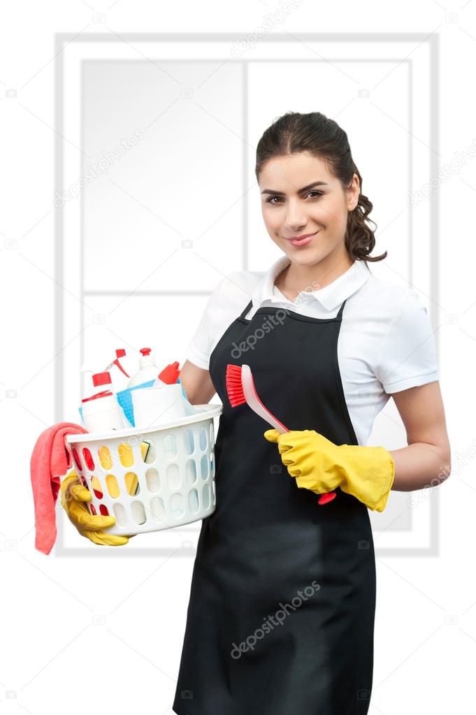 Portrait of cleaning lady holding a brush and a basket