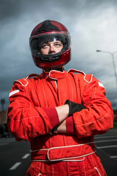 Racer wearing red racing protective suit and helmet — Stock Photo, Image