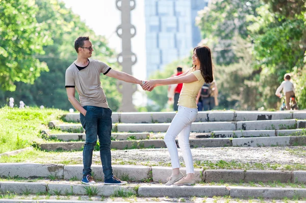 Allegro sorridente giovane uomo e donna nel parco — Foto Stock