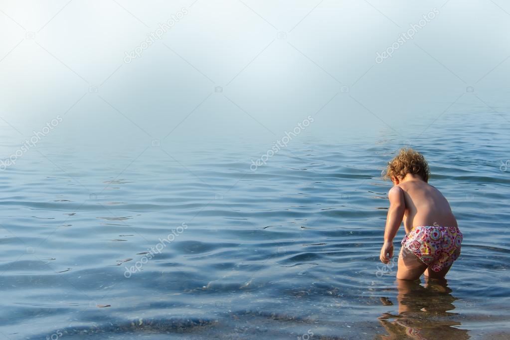 Cute little kid playing in the sea
