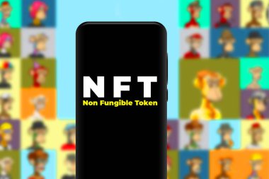 Smartphone with the acronym NFT logo refers to a non-fungible token, which refers to a digital asset that cannot be consumed or replaced.United States New York, January 18, 2022 clipart