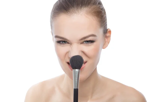 Mujer jugando con el cepillo de maquillaje, aislado en el fondo blanco — Foto de Stock