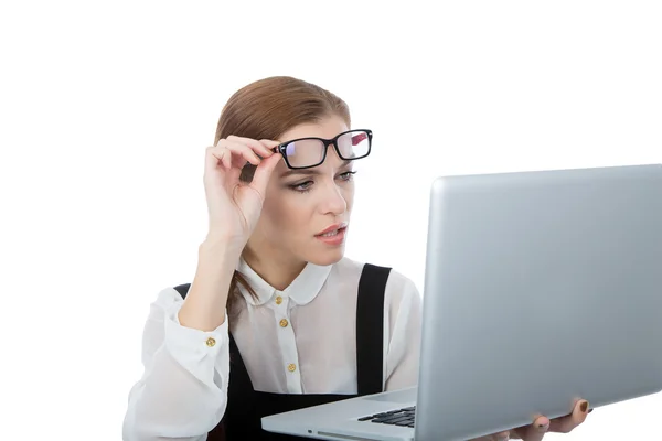 Woman with glasses looking in her laptop Stock Picture