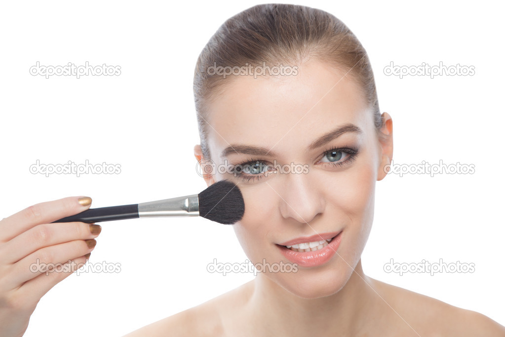 Woman using make-up brush, isolated on white background