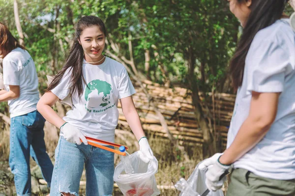 Group of asian diverse people volunteer teamwork, environment conservation, volunteer help to picking plastic and foam garbage on park area. Volunteering world environment day.