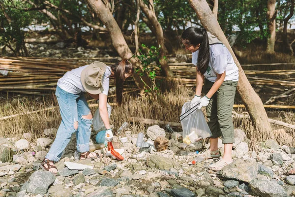 Group of asian diverse people volunteer teamwork ,environment conservation, volunteer help to picking plastic and foam garbage on park area. Volunteering world environment day.