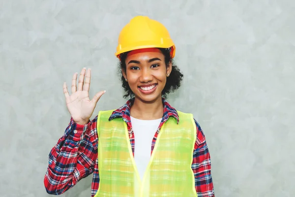 Portrait of professional young black woman civil engineer , architecture worker wearing hard hat safety for working in construction site or warehouse