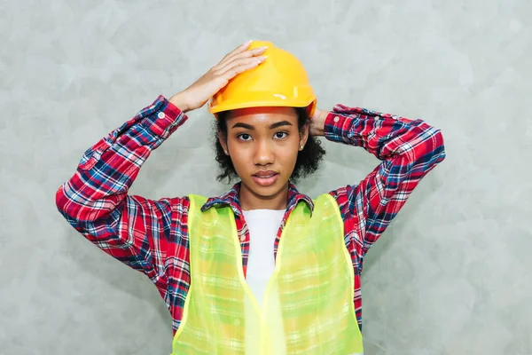 Portrait of professional young black woman civil engineer , architecture worker wearing hard hat safety for working in construction site or warehouse