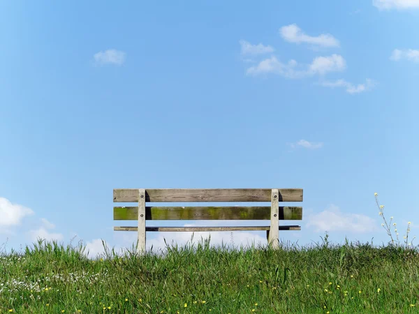 Park bench on a riverside in the Netherlands — Stock Photo, Image