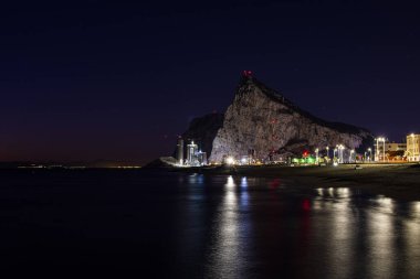 Gece boyunca Akdeniz 'deki Cebelitarık kayasına bakın La Linea de la Concepcion' dan.