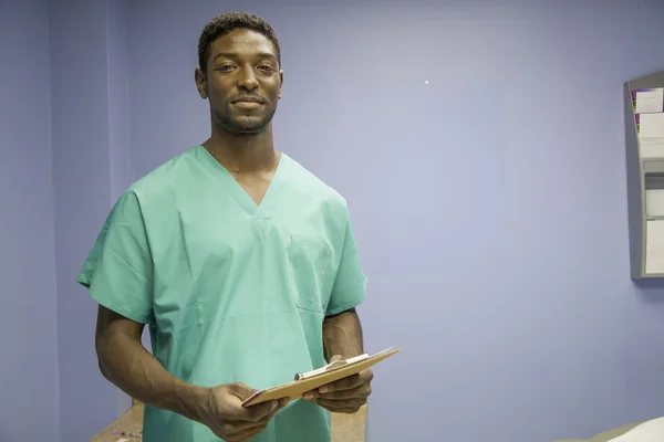 African american doctor reads medical charts — Stock Photo, Image