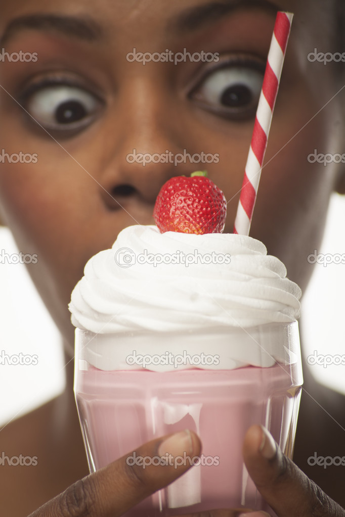 african american girl holding milkshake