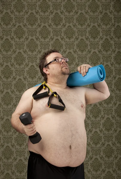 Shirtless, overweight male holding excercise equipment feeling p Zdjęcia Stockowe bez tantiem