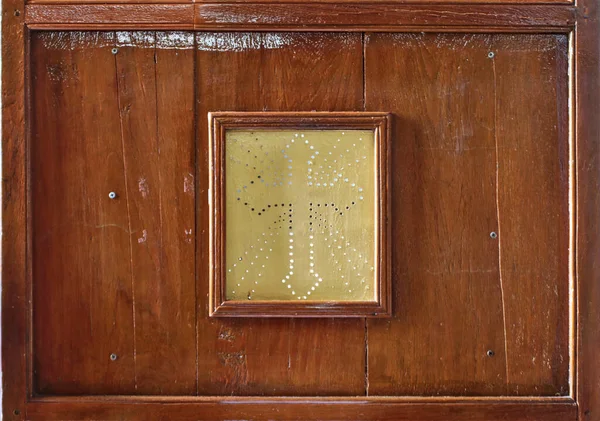 The old wooden window of the church confession cabinet.