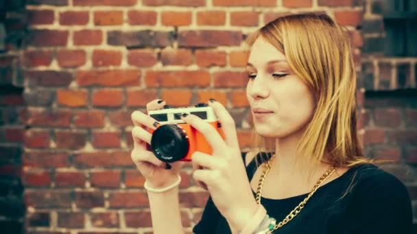 Teenage woman having fun taking pictures with old camera