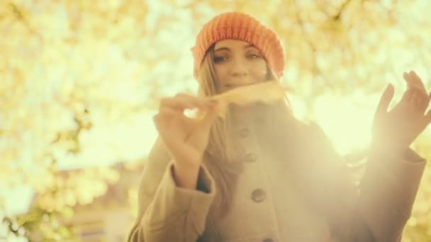 Woman playing with Autumn leaf and falling leafs — Stock Video