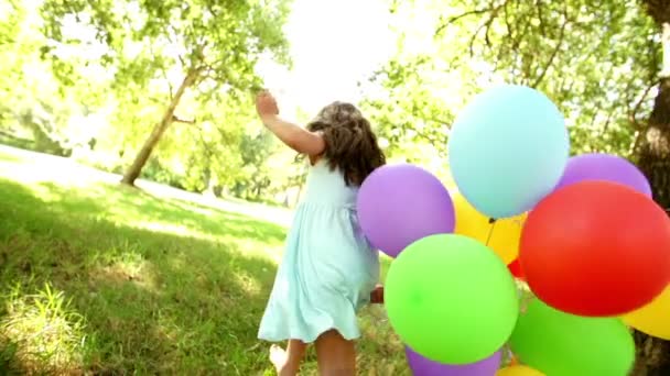 Girl running with balloons — Stock Video