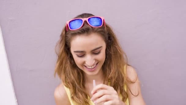 Chica sonriendo a la cámara con batido — Vídeo de stock