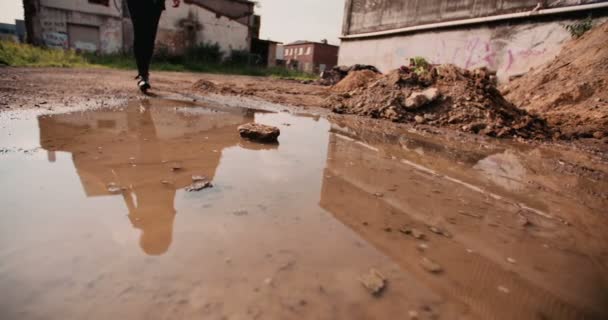 Teenage Girl Jumping Muddy Puddle Industrial Area Stock Video