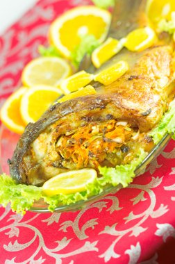 Baked fish stuffed with vegetables clipart