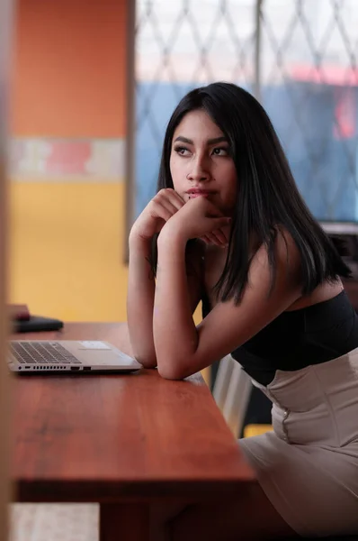 Thoughtful Hispanic Woman Leaning Wooden Table Concept Tiredness Job — ストック写真